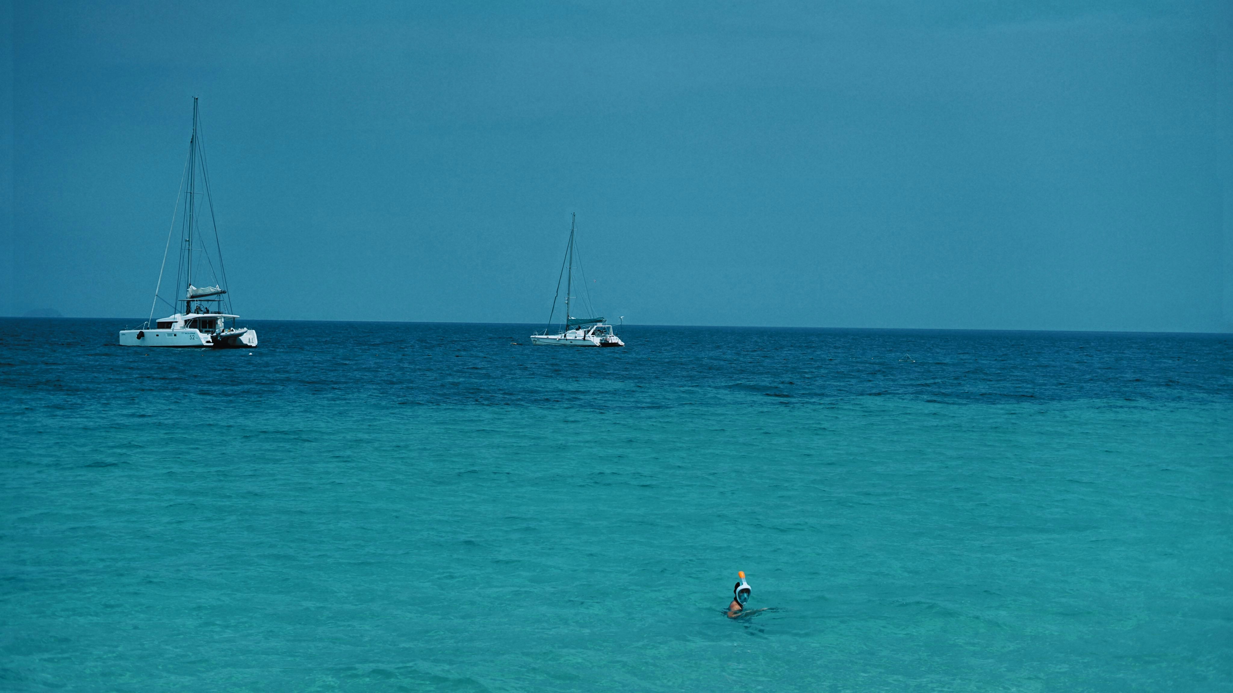 blue waters and white sailing boats